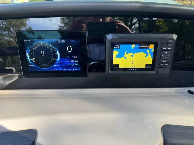 Slide: The Image of The image shows the dashboard of a Bennington 22 SSRX with digital displays and a Garmin navigation system. - 13