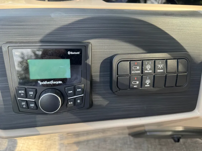 Slide: The Image of Close-up of a boat control panel with radio and switches. - 14