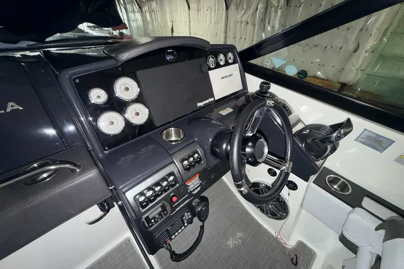 Slide: The Image of 2019 Formula 350 Crossover Bowrider I/O dashboard with steering wheel and control panel. - 18