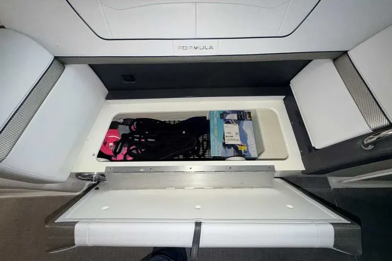 Slide: The Image of 2019 Formula 350 Crossover Bowrider I/O storage compartment with boating accessories. - 13