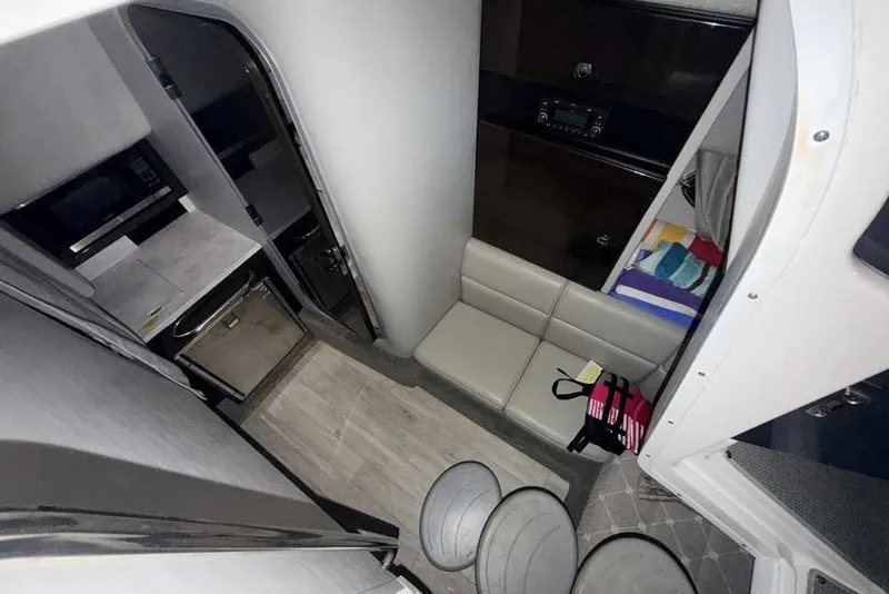 Slide: The Image of Interior of 2019 Formula 350 Crossover Bowrider I/O with seating, kitchenette, and storage. - 33