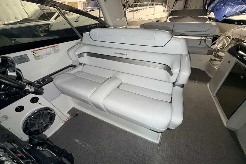 Slide: The Image of 2019 Formula 350 Crossover Bowrider I/O interior with plush seating and modern dashboard. - 15