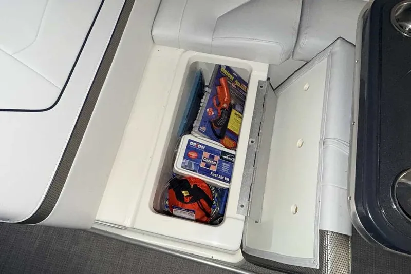 Slide: The Image of Storage compartment in a 2019 Formula 350 Crossover Bowrider I/O with safety equipment. - 8