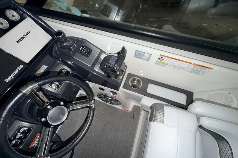 Slide: The Image of 2019 Formula 350 Crossover Bowrider I/O cockpit with steering wheel and control panel. - 19