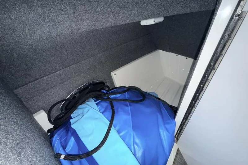 Slide: The Image of Storage compartment in 2019 Formula 350 Crossover Bowrider I/O with blue bag inside. - 22