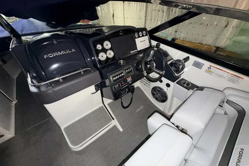 Slide: The Image of 2019 Formula 350 Crossover Bowrider I/O cockpit with modern controls and seating. - 17