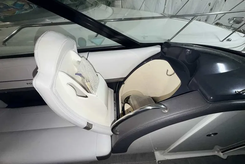 Slide: The Image of 2019 Formula 350 Crossover Bowrider I/O interior with white seating and storage compartment. - 14