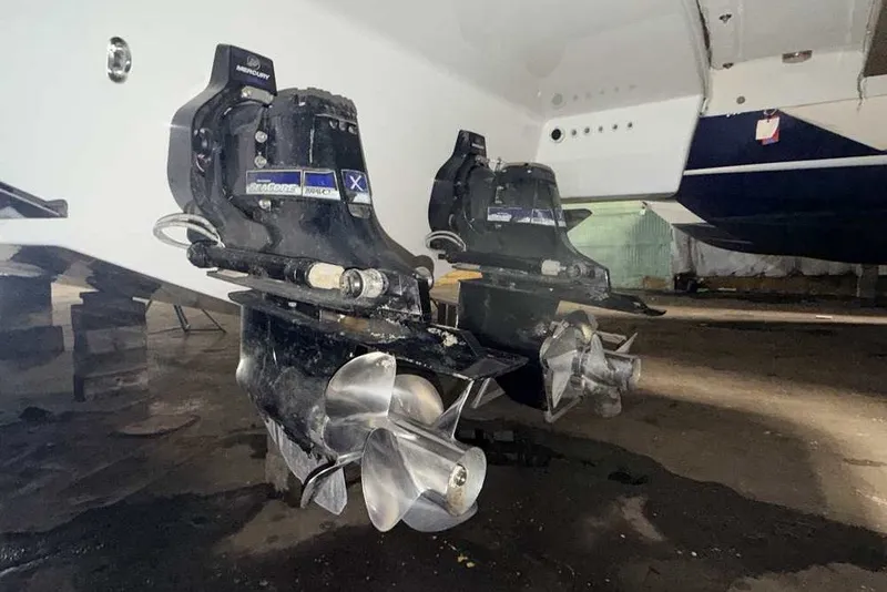 Slide: The Image of 2019 Formula 350 Crossover Bowrider I/O with dual propellers in a garage setting. - 1