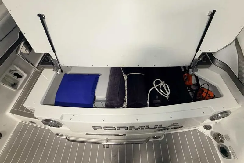 Slide: The Image of 2019 Formula 350 Crossover Bowrider I/O storage compartment with equipment and accessories. - 5