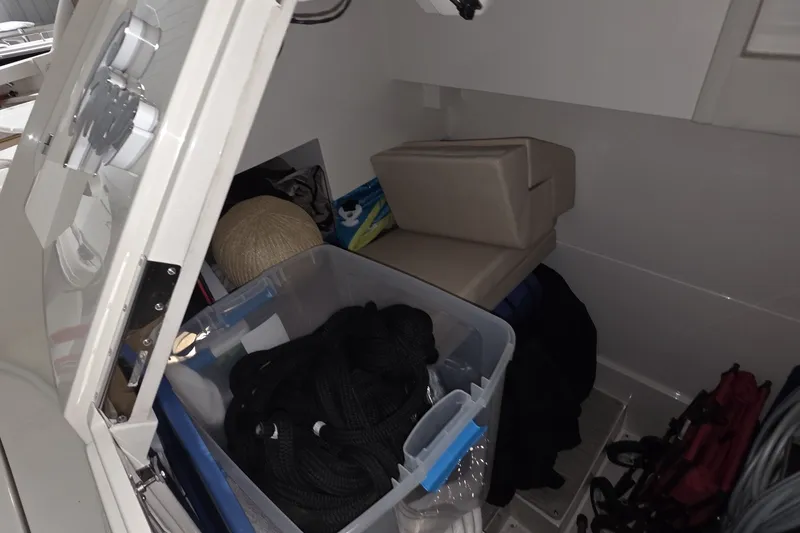 Slide: The Image of Storage compartment in a 2018 Carver C52 Coupe with ropes and cushions. - 33