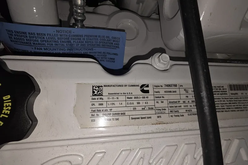 Slide: The Image of Engine label of a 2018 Carver C52 Coupe with Cummins specifications. - 63
