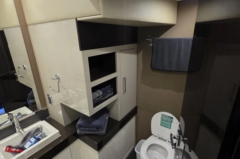 Slide: The Image of Luxurious bathroom in 2018 Carver C52 Coupe yacht with modern fixtures and storage. - 26