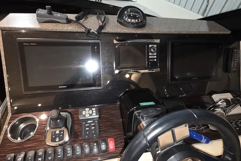 Slide: The Image of Dashboard of a 2018 Carver C52 Coupe with navigation and control systems. - 31
