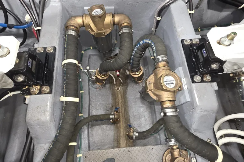 Slide: The Image of Engine compartment of a 2018 Carver C52 Coupe, showcasing hoses and mechanical components. - 58