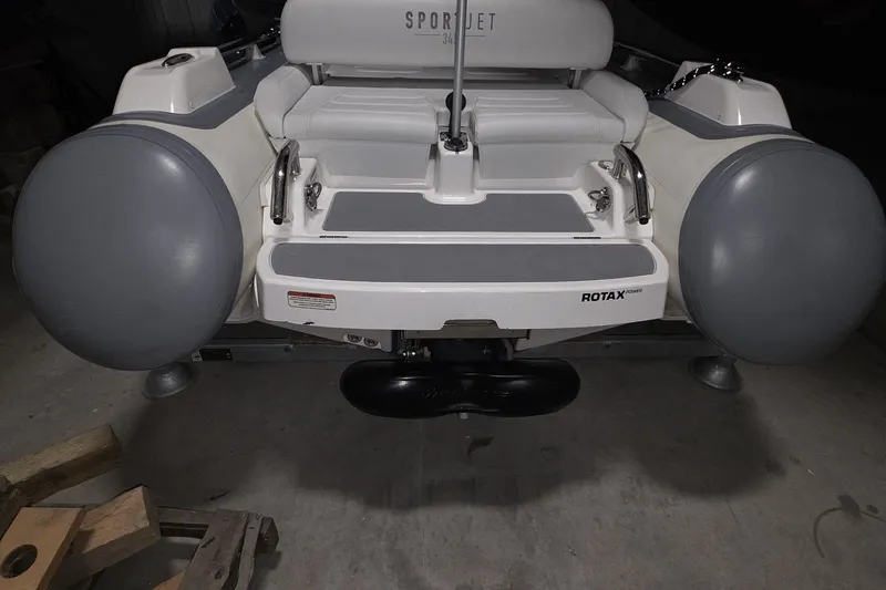 Slide: The Image of Rear view of a 2018 Carver C52 Coupe with Rotax engine and SportJet seating. - 67