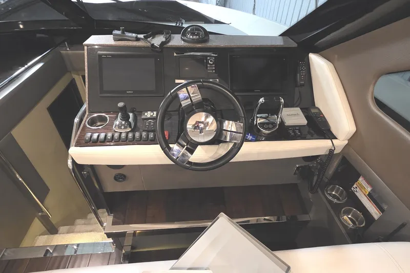 Slide: The Image of Helm of 2018 Carver C52 Coupe with modern navigation controls and steering wheel. - 17