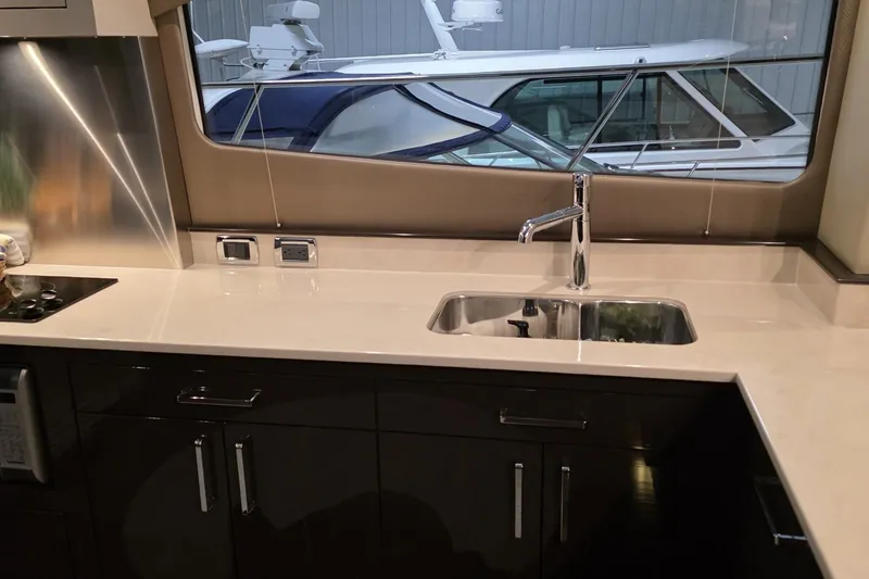 Slide: The Image of Luxurious kitchen interior of 2018 Carver C52 Coupe yacht with sleek countertops and modern fixtures. - 15
