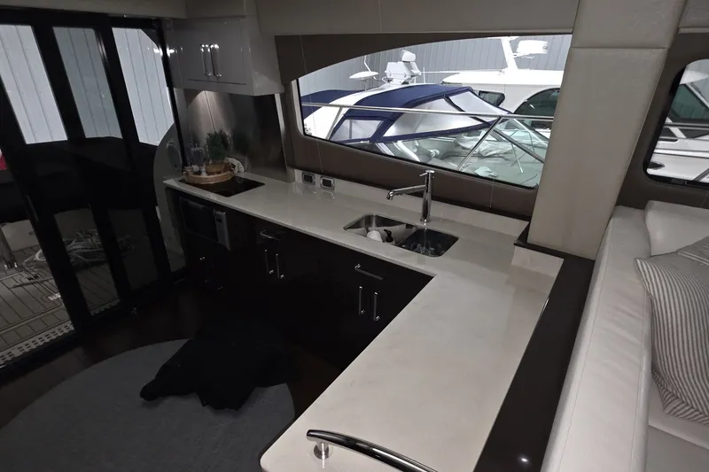 Slide: The Image of Luxurious interior of 2018 Carver C52 Coupe yacht with modern kitchen and sleek design. - 14