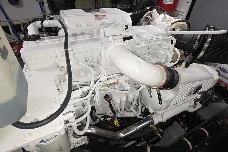 Slide: The Image of Engine of a 2018 Carver C52 Coupe, showcasing intricate mechanical components. - 61