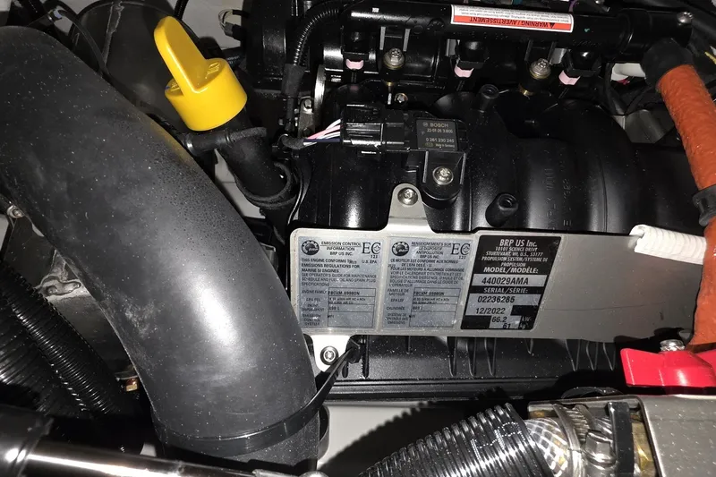 Slide: The Image of Engine compartment of a 2018 Carver C52 Coupe with visible labels and components. - 69