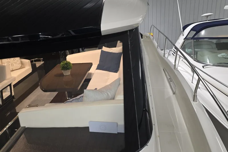Slide: The Image of 2018 Carver C52 Coupe yacht interior with elegant seating and table arrangement. - 48