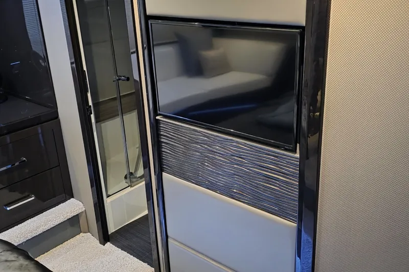 Slide: The Image of Interior of 2018 Carver C52 Coupe featuring modern TV and sleek design elements. - 46