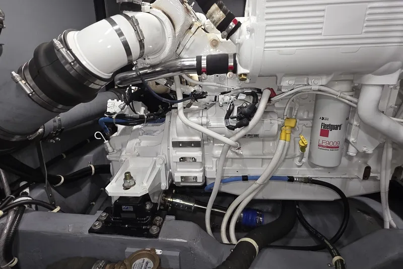 Slide: The Image of Engine room of a 2018 Carver C52 Coupe, showcasing detailed mechanical components. - 59