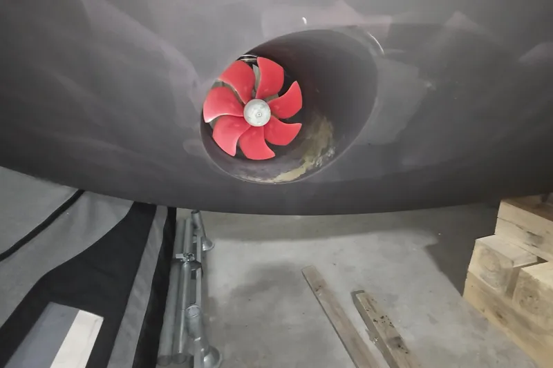 Slide: The Image of Red propeller of a 2018 Carver C52 Coupe in a boat garage. - 37