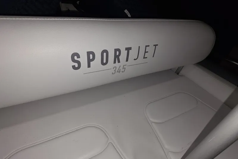 Slide: The Image of White leather seat with "SPORTJET 345" text, inside a 2018 Carver C52 Coupe. - 64