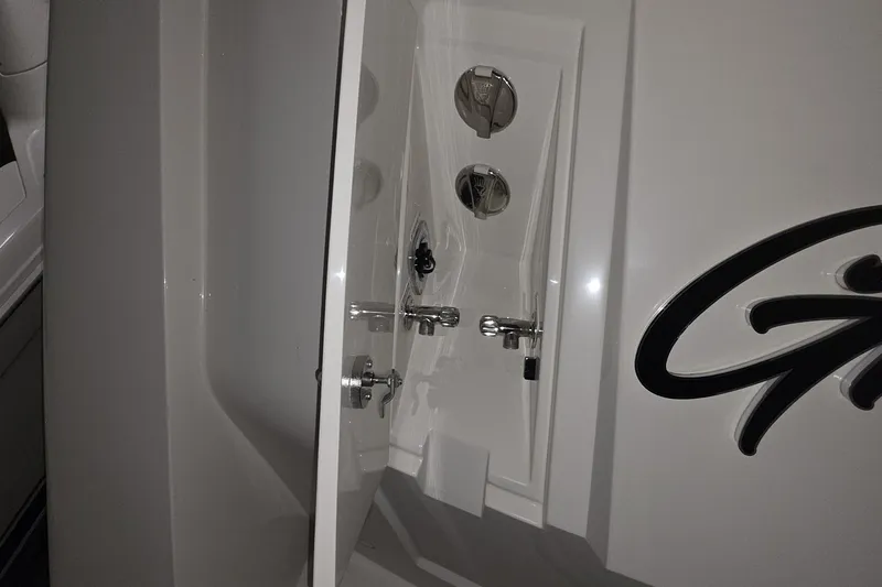 Slide: The Image of 2018 Carver C52 Coupe yacht interior with sleek white design and chrome fixtures. - 22