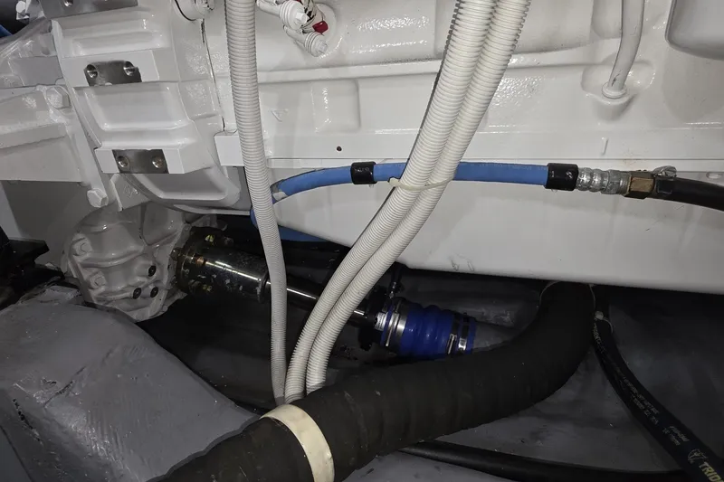 Slide: The Image of Engine compartment of a 2018 Carver C52 Coupe with visible hoses and components. - 56
