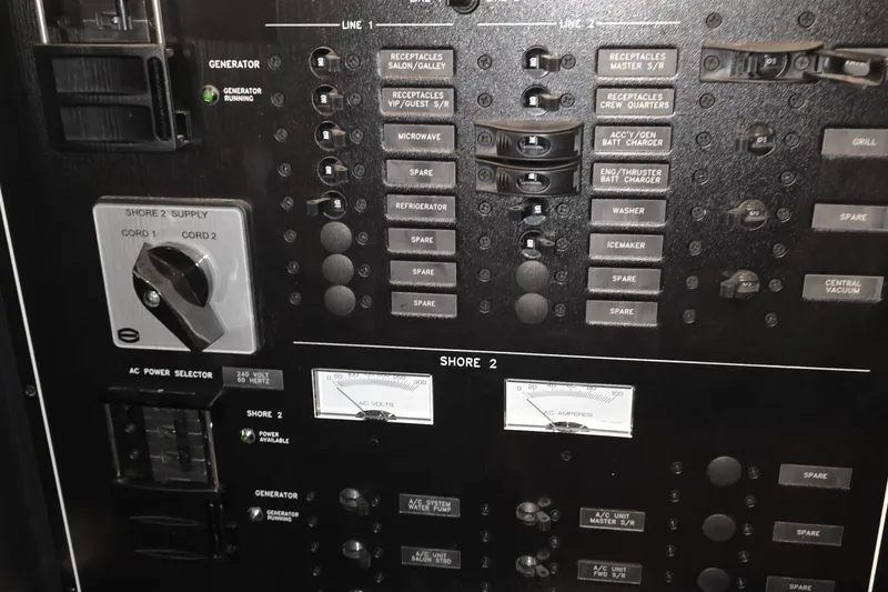 Slide: The Image of Electrical control panel of a 2018 Carver C52 Coupe yacht, featuring various switches and indicators. - 52
