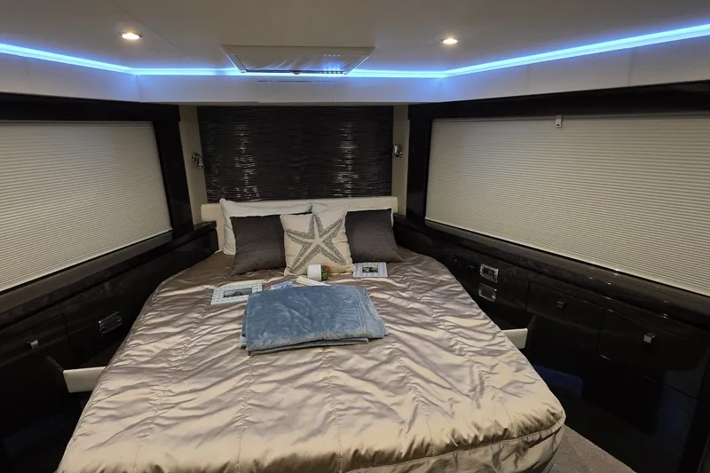Slide: The Image of Luxurious bedroom interior of 2018 Carver C52 Coupe yacht with modern lighting and decor. - 42
