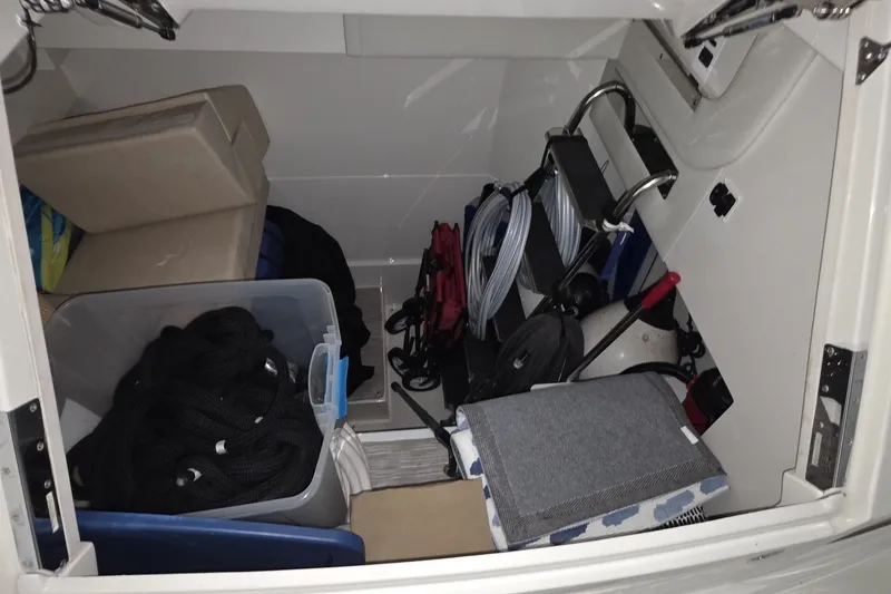 Slide: The Image of Storage compartment of 2018 Carver C52 Coupe with ropes, cushions, and equipment. - 25