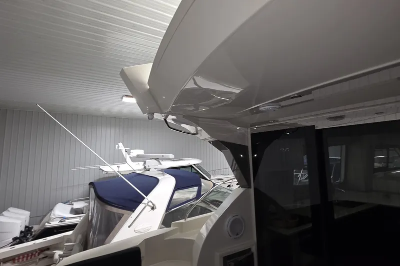 Slide: The Image of 2018 Carver C52 Coupe yacht in indoor storage, showcasing sleek design and modern features. - 36