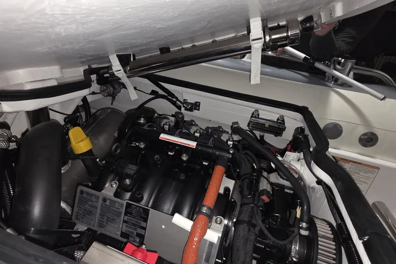 Slide: The Image of Engine compartment of a 2018 Carver C52 Coupe, showcasing detailed mechanical components. - 70