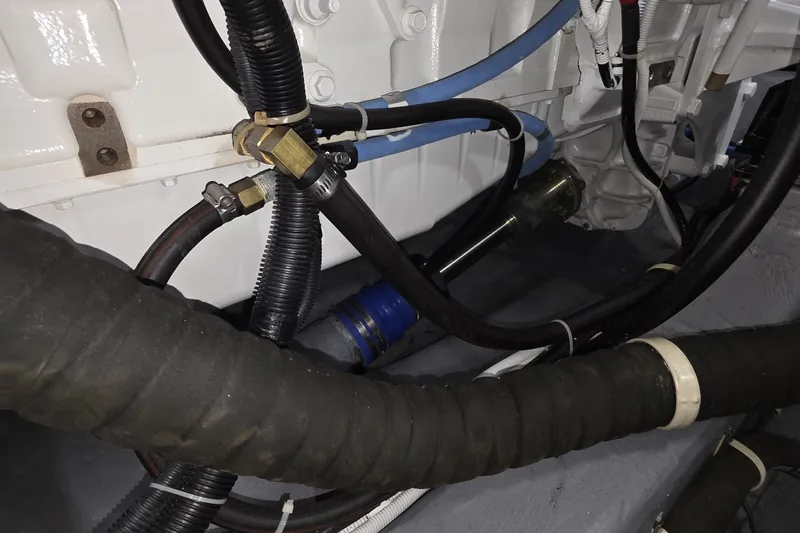 Slide: The Image of Engine compartment of 2018 Carver C52 Coupe with visible hoses and fittings. - 60