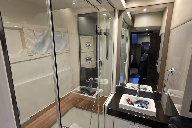 Slide: The Image of Luxurious bathroom interior of 2018 Carver C52 Coupe yacht with modern fixtures and glass shower. - 29