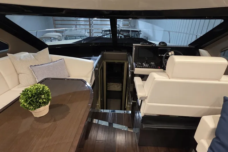 Slide: The Image of Luxurious interior of 2018 Carver C52 Coupe yacht with plush seating and modern helm. - 21