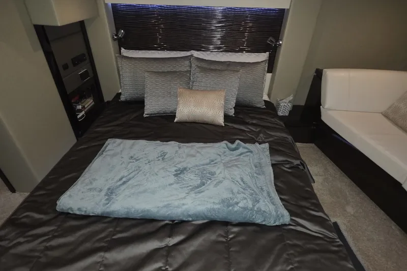 Slide: The Image of Luxurious bedroom interior of 2018 Carver C52 Coupe yacht with elegant bedding and cushions. - 47