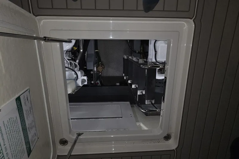 Slide: The Image of Engine compartment of a 2018 Carver C52 Coupe yacht, showcasing mechanical components. - 53