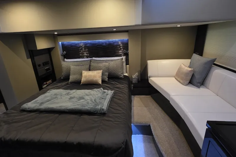 Slide: The Image of Luxurious interior of 2018 Carver C52 Coupe yacht with cozy bed and seating area. - 50