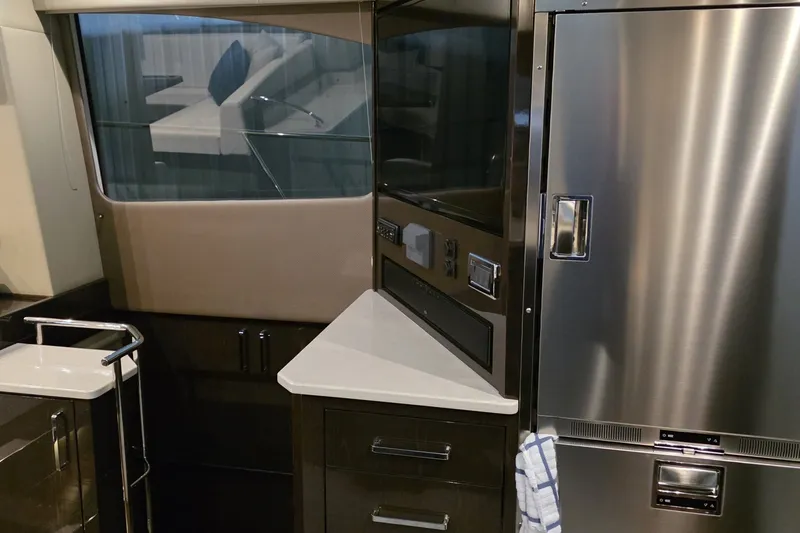 Slide: The Image of Interior of 2018 Carver C52 Coupe yacht with modern kitchen appliances. - 34