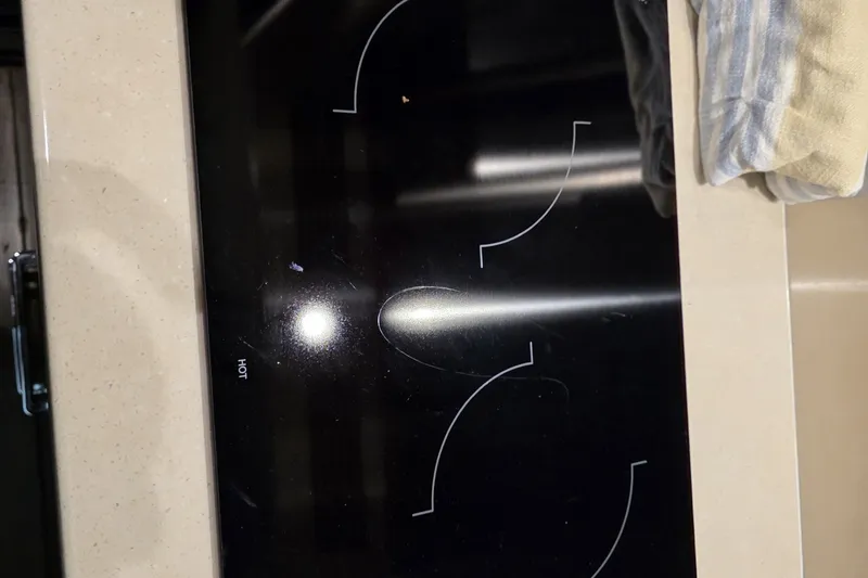 Slide: The Image of Modern induction cooktop with a sleek black surface and visible heating zones. - 41