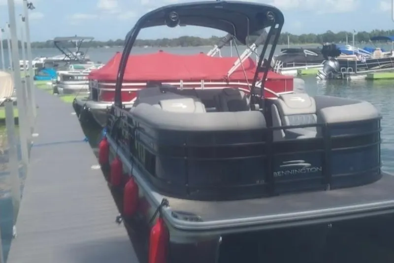 The Image of 2023 Bennington 24 LXS Swingback pontoon boat docked on a sunny day. - 0