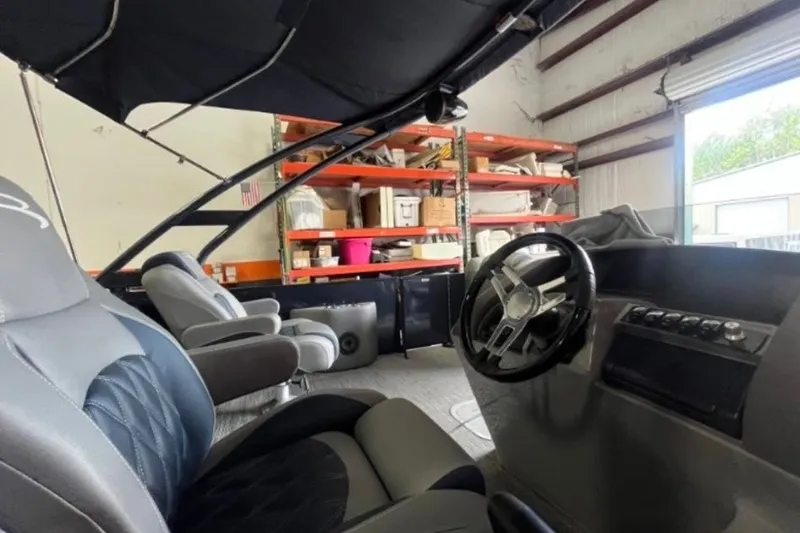 Slide: The Image of Interior of 2023 Bennington 24 LXS Swingback pontoon boat in a storage facility. - 9