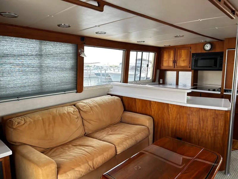 Slide: The Image of Interior of 2003 Nordic Tug 52 with sofa, kitchenette, and wooden cabinetry. - 41