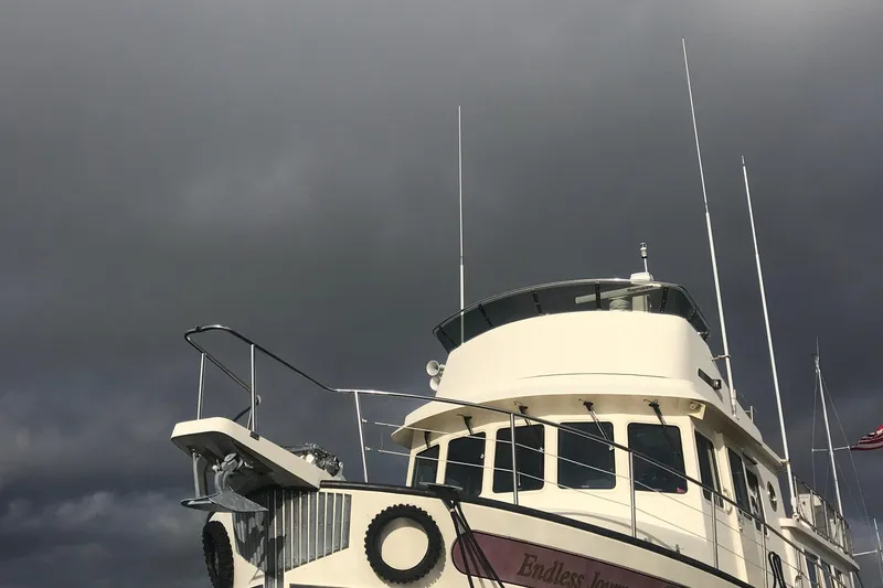 Slide: The Image of Nordic Tug 52 boat from 2003 under dark, cloudy skies. - 8