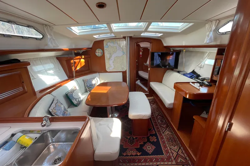 Slide: The Image of Luxurious interior of a 2007 Beneteau 393 yacht with elegant wood finish and cozy seating. - 1