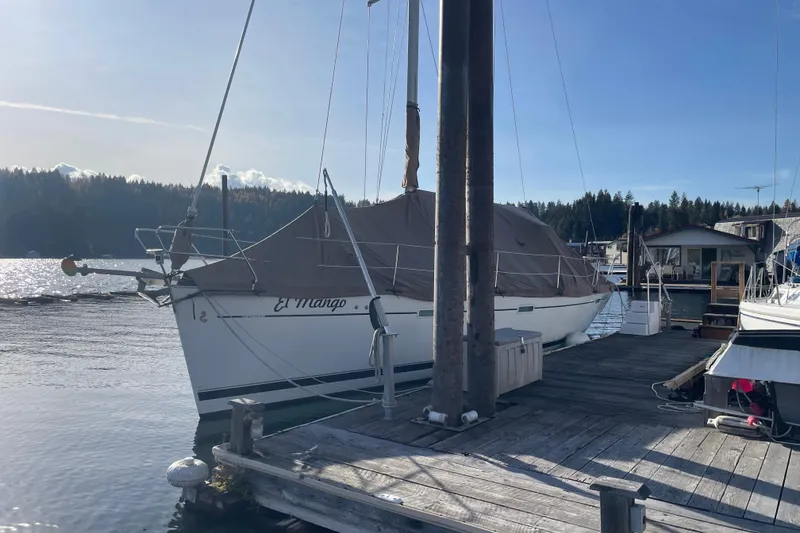 Slide: The Image of 2007 Beneteau 393 sailboat docked at a marina, covered, with scenic waterfront view. - 21